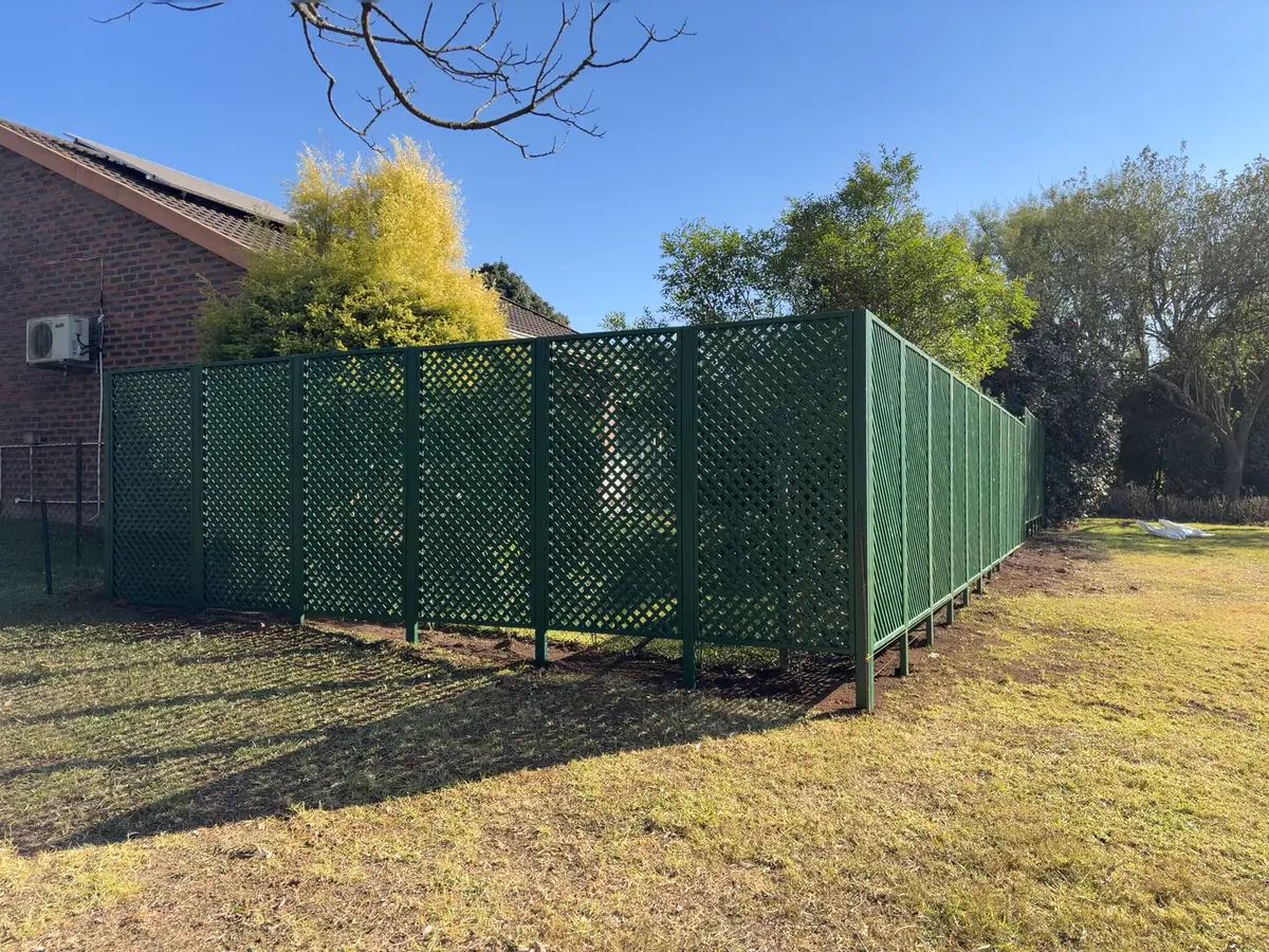 Completed green lattice trellis screening around a garden in Howick