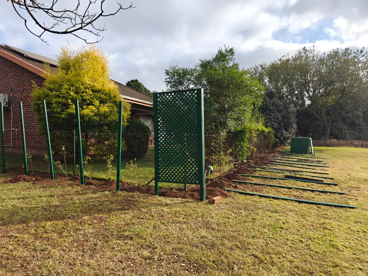 Partially installed trellis screen with posts and panels awaiting completion in Howick